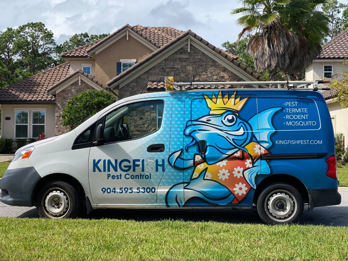 a blue truck parked in front of a house