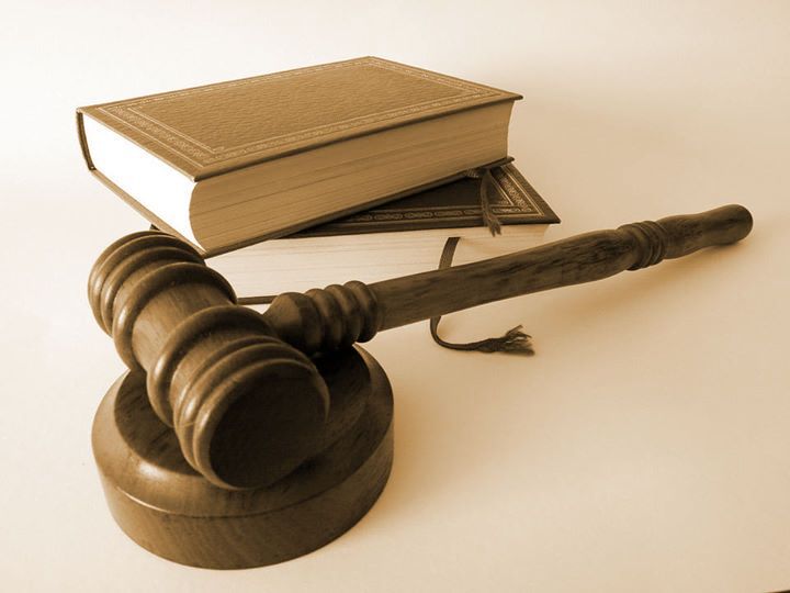 a gavel next to a stack of books