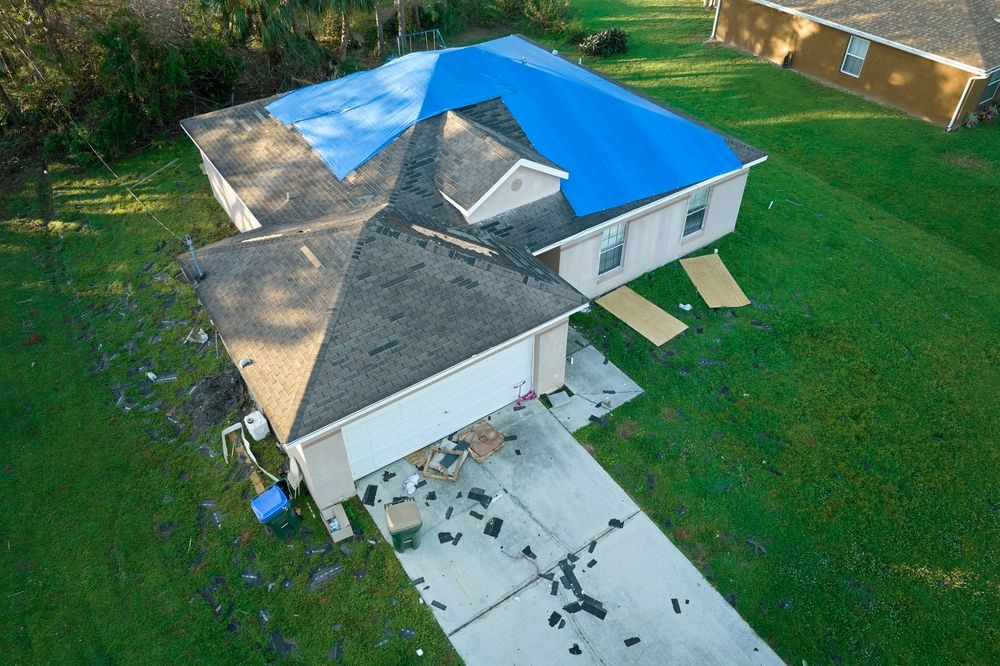 tarp on damaged roof from water leak
