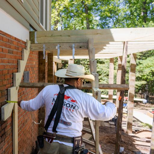 Nelson Exteriors employee aligning deck framework how to tell if deck boards need replaced service in Marietta GA by Nelson Exteriors