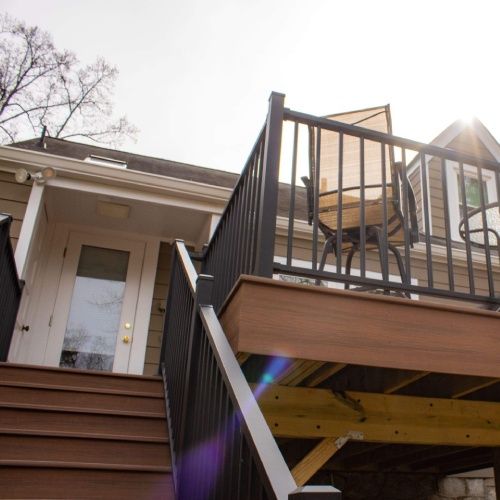 Exterior elevated deck with stairs and railing by Nelson Exteriors