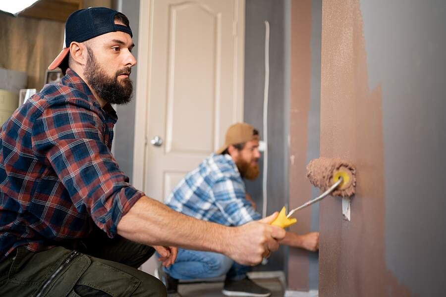 men painting house