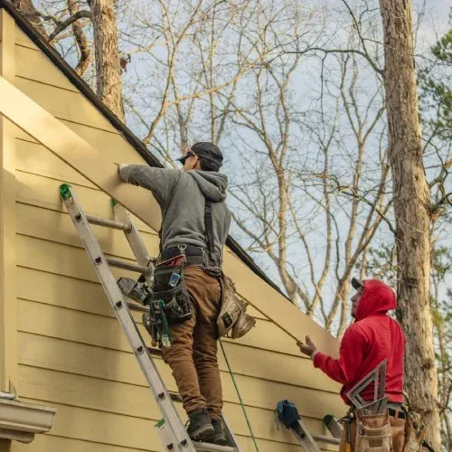 Nelson Exteriors team performing siding replacement on an Atlanta home exterior