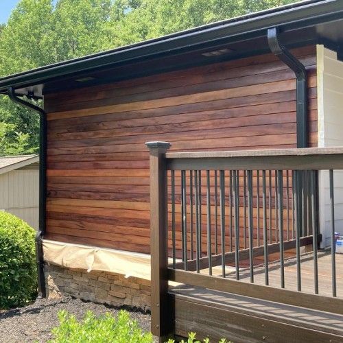 Modern home exterior featuring rich Brazilian hardwood siding by Nelson Exteriors