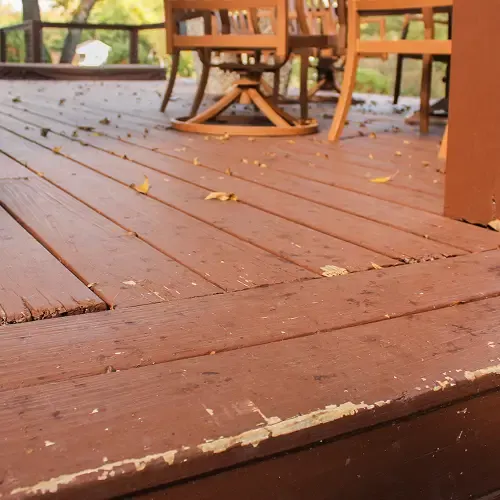 Weathered wooden deck with outdoor seating showing wear and wood damage by Nelson Exteriors in Atlanta, GA