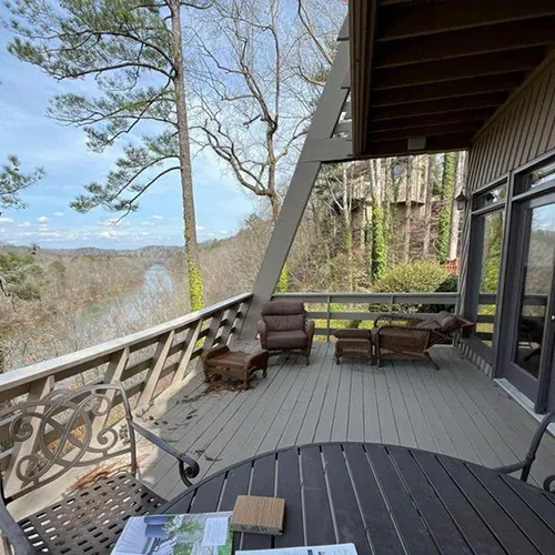 Two-tier deck with comfortable outdoor furniture by Nelson Exteriors in Marietta