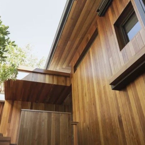 Modern architectural design using vertical Brazilian hardwood siding by Nelson Exteriors