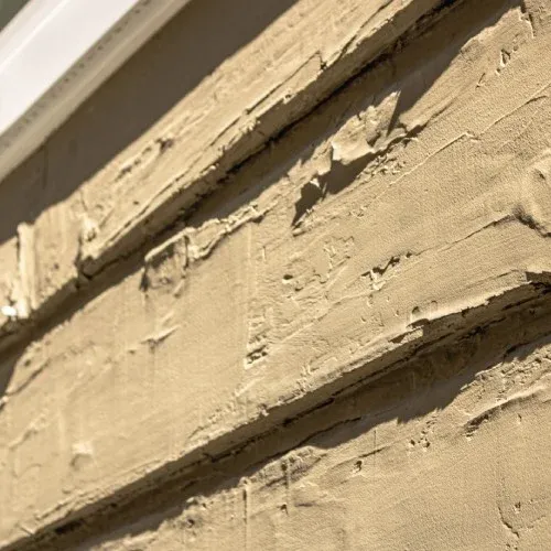 Warped exterior siding panels with peeling paint indicating replacement need by Nelson Exteriors in Atlanta, GA