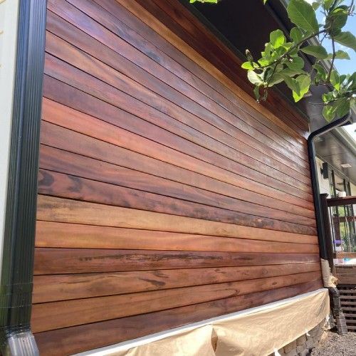 Custom home exterior finished with premium Brazilian hardwood siding by Nelson Exteriors