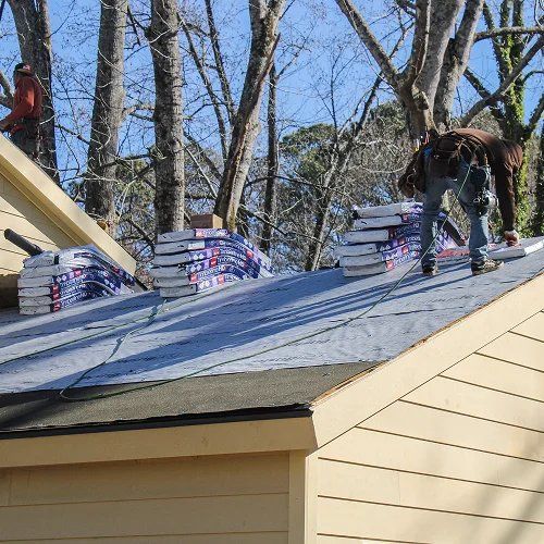 Roofing team installing materials for instant roof quote by Nelson Exteriors in GA