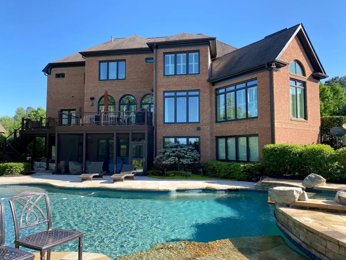 Brick home with black trimmed casement windows