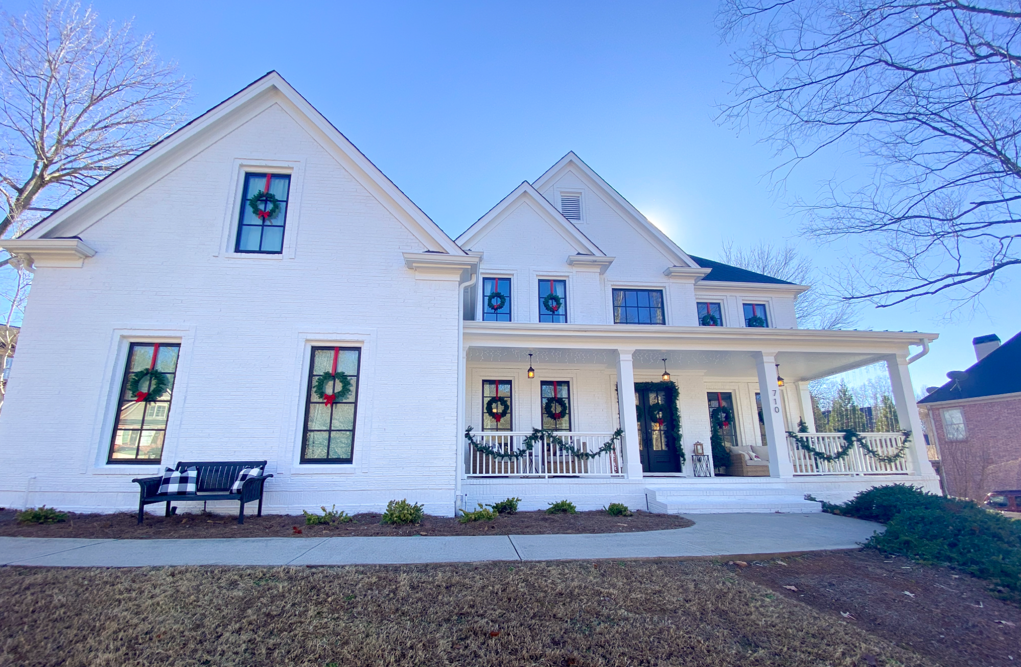 White brick home with black Infinity from Marvin Fiberglass Windows.