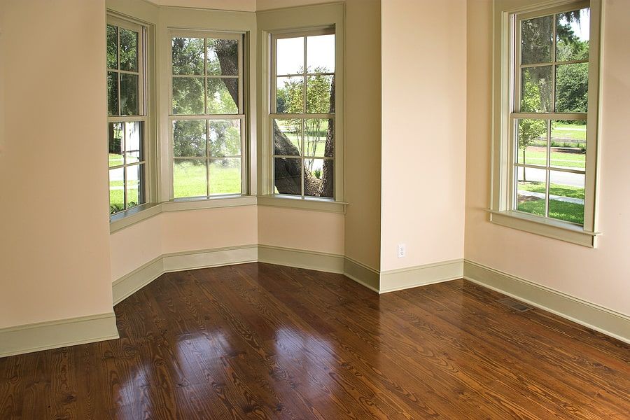 Bay window with beige walls and wood floors