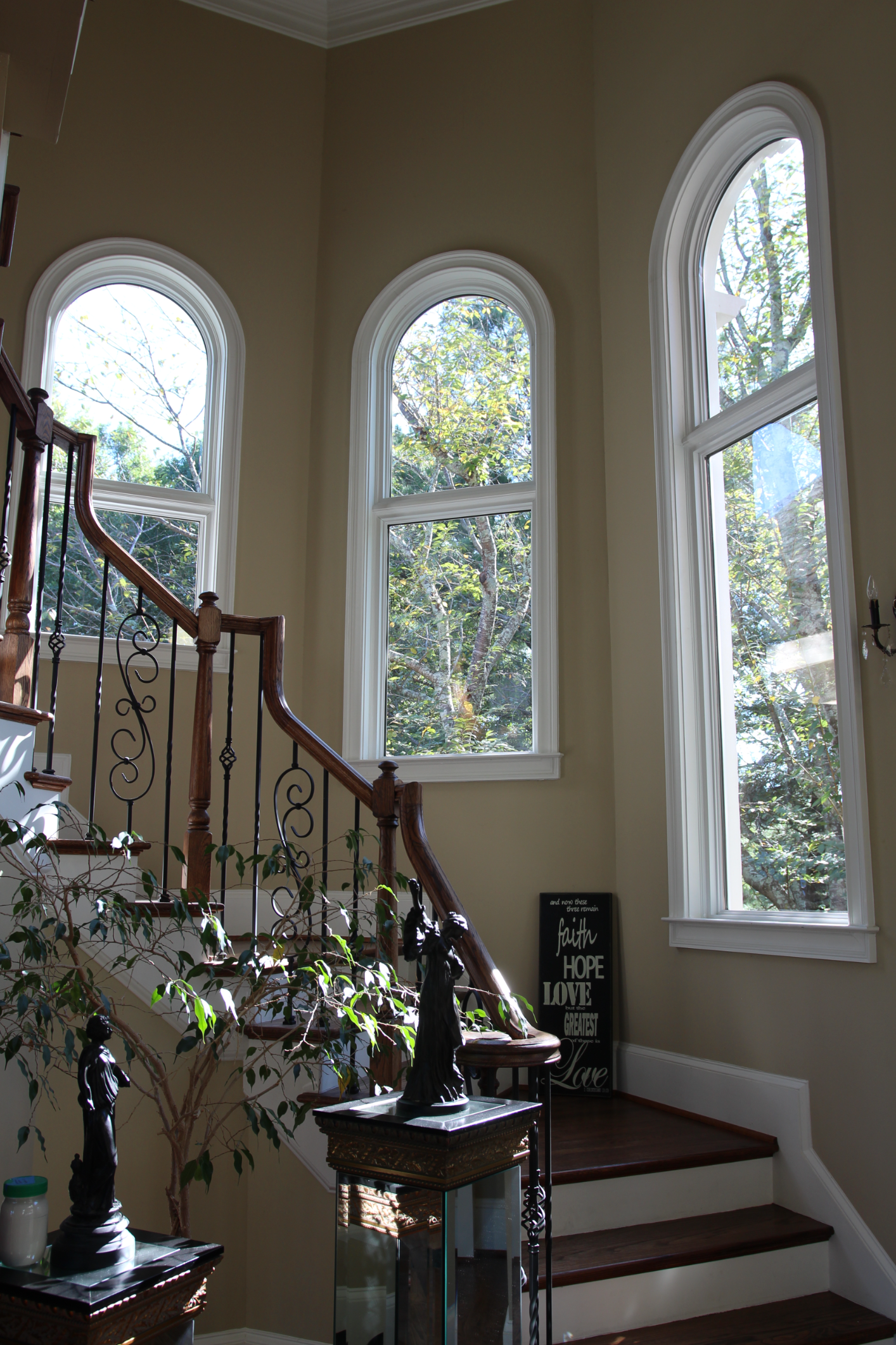 Rounded windows above a winding staircase installed by North Georgia Replacement Windows