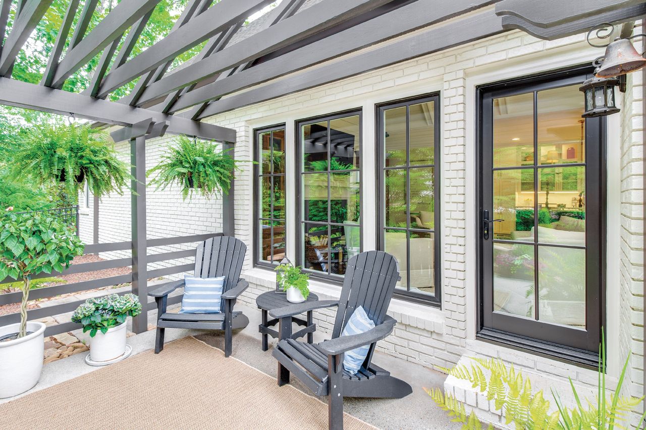 Bronze fiberglass window frames on a white brick home