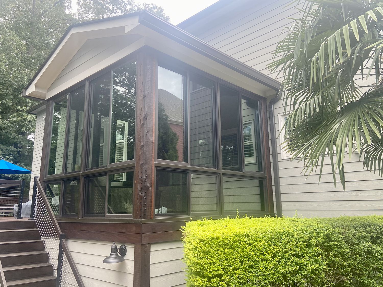 Georgia home with four season room featuring black framed windows and wood trim built by North Georgia Replacement Windows