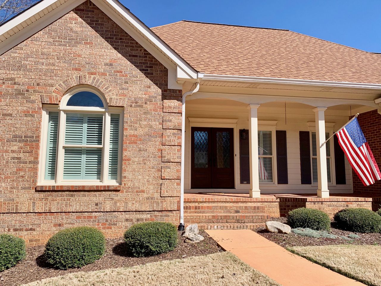 Sierra color window frames on a brick home