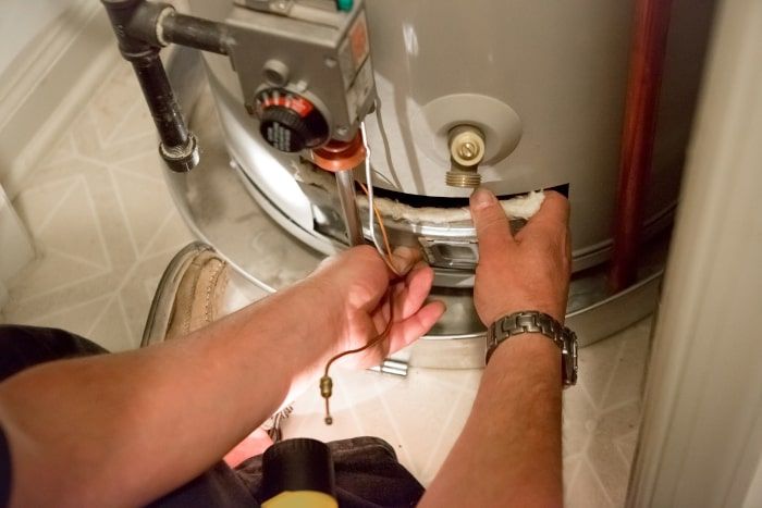 Person Replacing a Water Heater