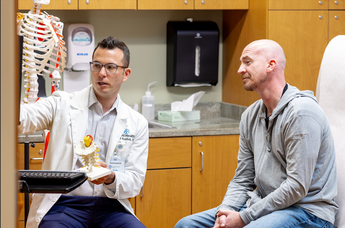 Reid Bone & Joint Center Spine Surgeon, Dr. Kostiuk and patient