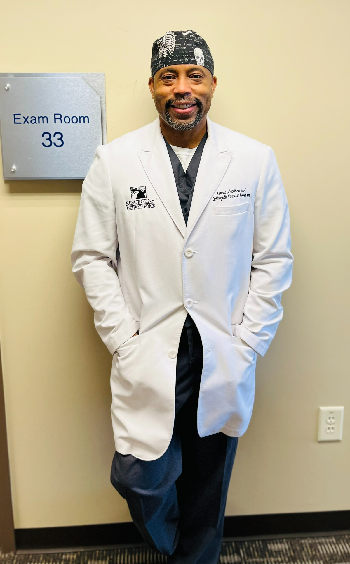 Arnrae U. Moultrie, a physician assistant, poses outside an exam room.