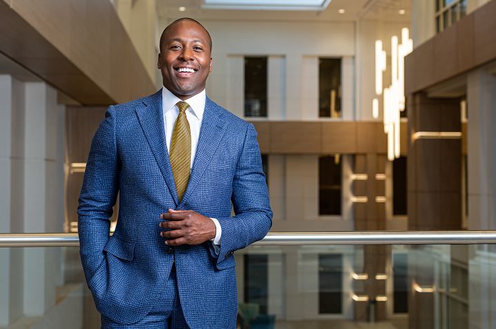 Dr. Elvis Francois poses in the lobby of an office building.