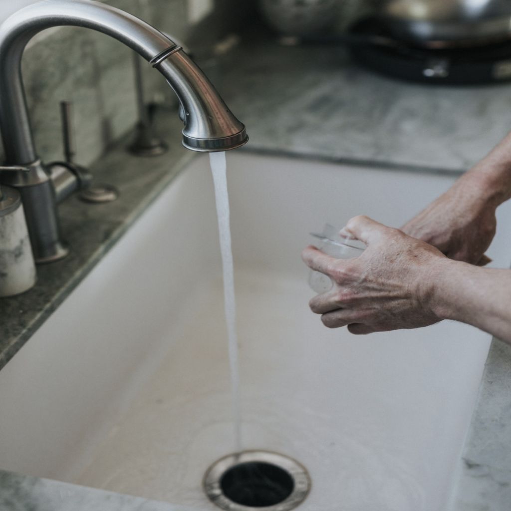 a man cleaning things out of an atlanta sink