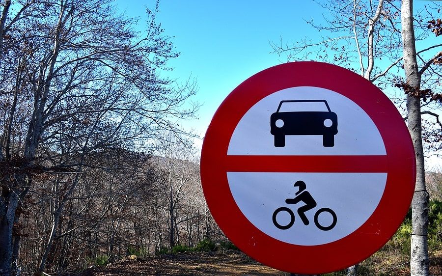  A sign with a motorcycle rider and a car