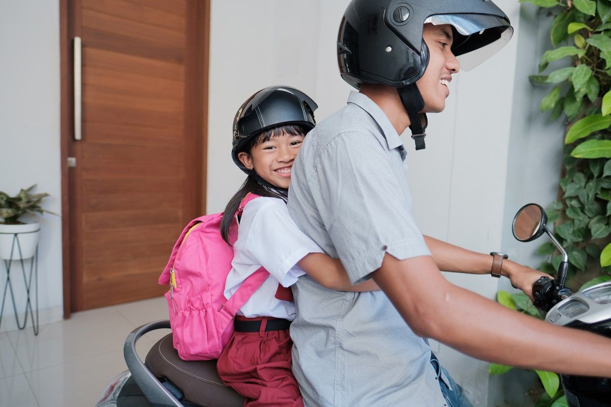 Kids ride shop on motorcycle