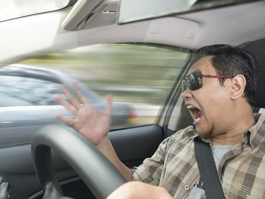 A man yelling while in the car driving 