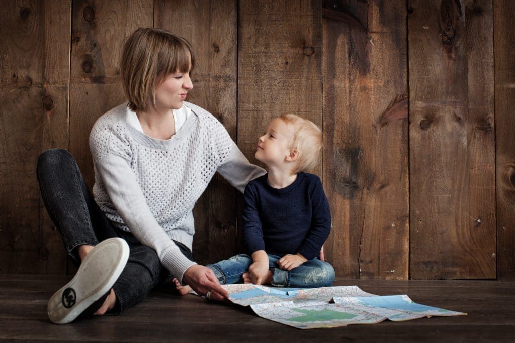 A young child and mother looking at each other