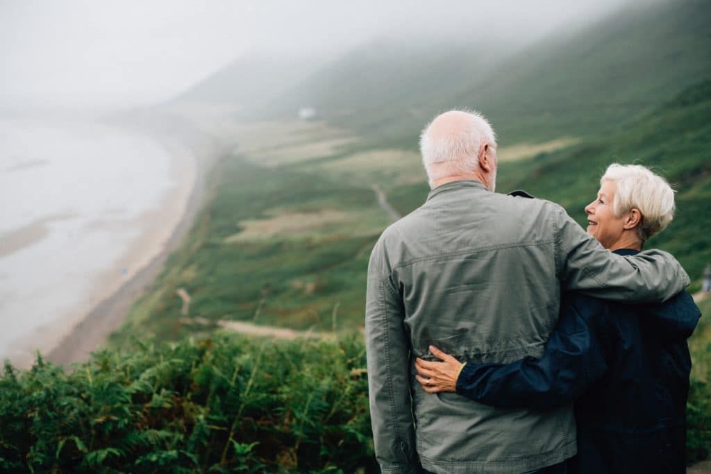 an older couple looking at the sea