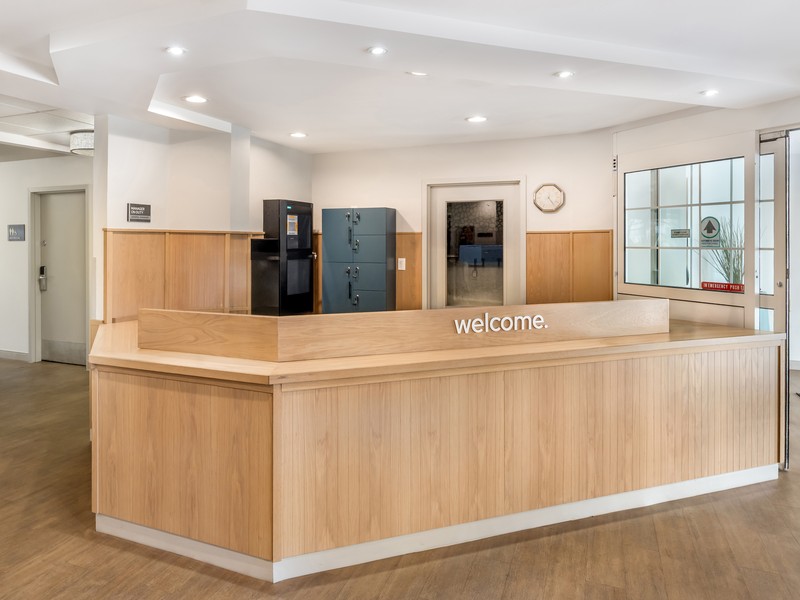 Sonesta Simply Suites Custom Reception Desk Featuring Stained White Oak Paneling