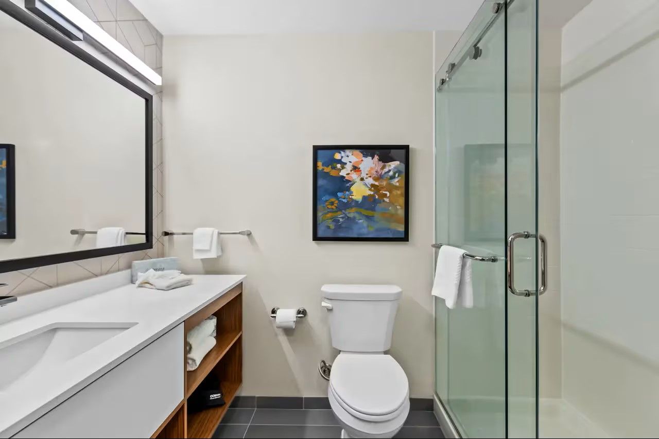 Everhome Suites by Choice Custom Bath Shower Doors, Quartz Countertops, and Millwork