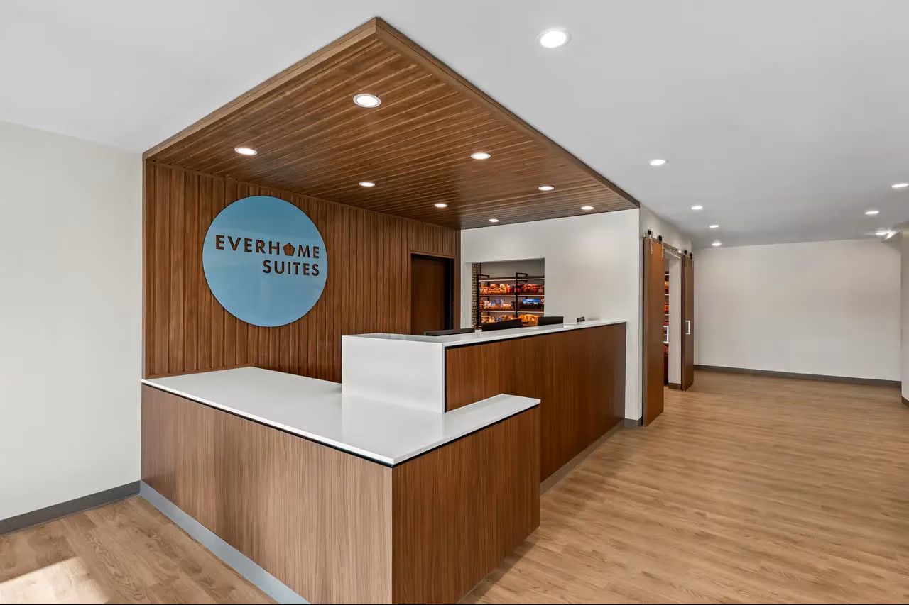 Everhome Suites by Choice Custom Front Desk and Market Millwork, Quartz Countertops, and Sliding Barn Doors