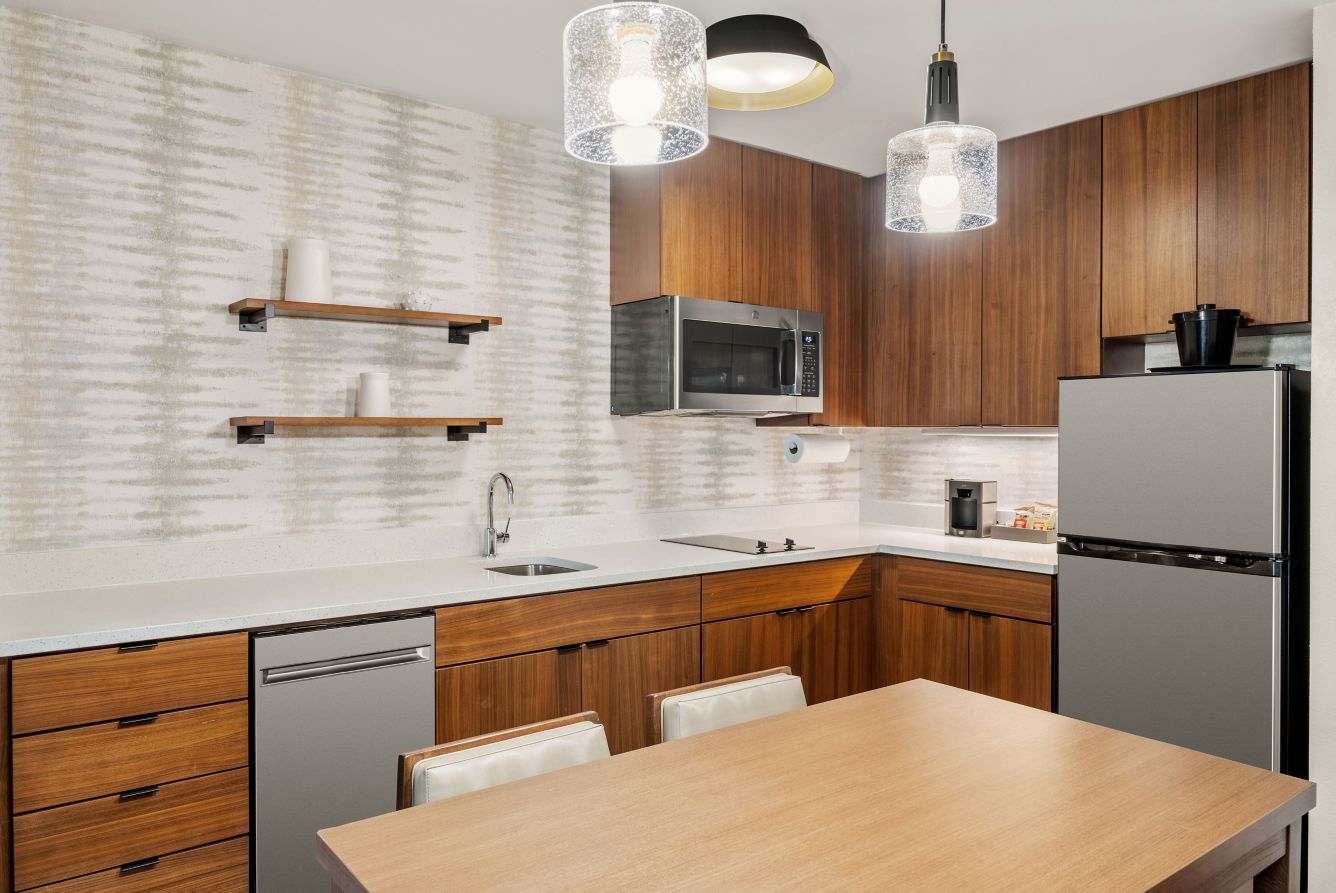 Residence Inn Custom Guest Kitchen Walnut-Stained Cabinets and Quartz