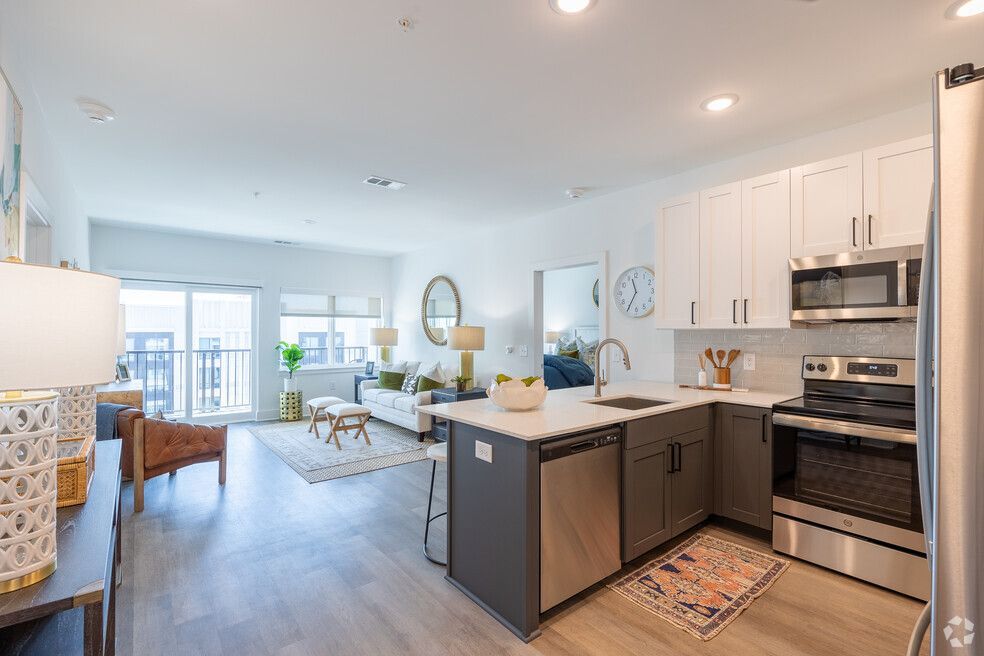 The National Apartments Unit Kitchen Featuring Custom Quartz Counters