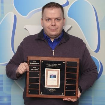 a man holding a plaque