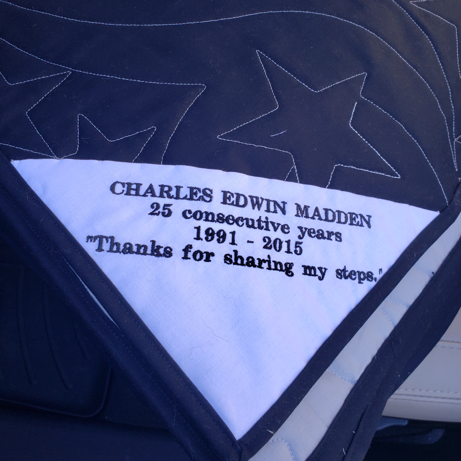 The back of the quilt reading &quot;Charles Edwin Madden 25 Consecutive Years 1991-2015 Thanks for sharing my steps.&quot;