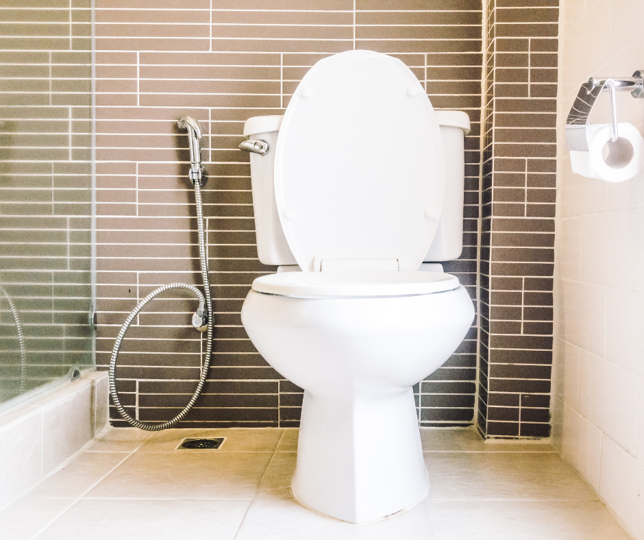 White toilet on white tile in bathroom