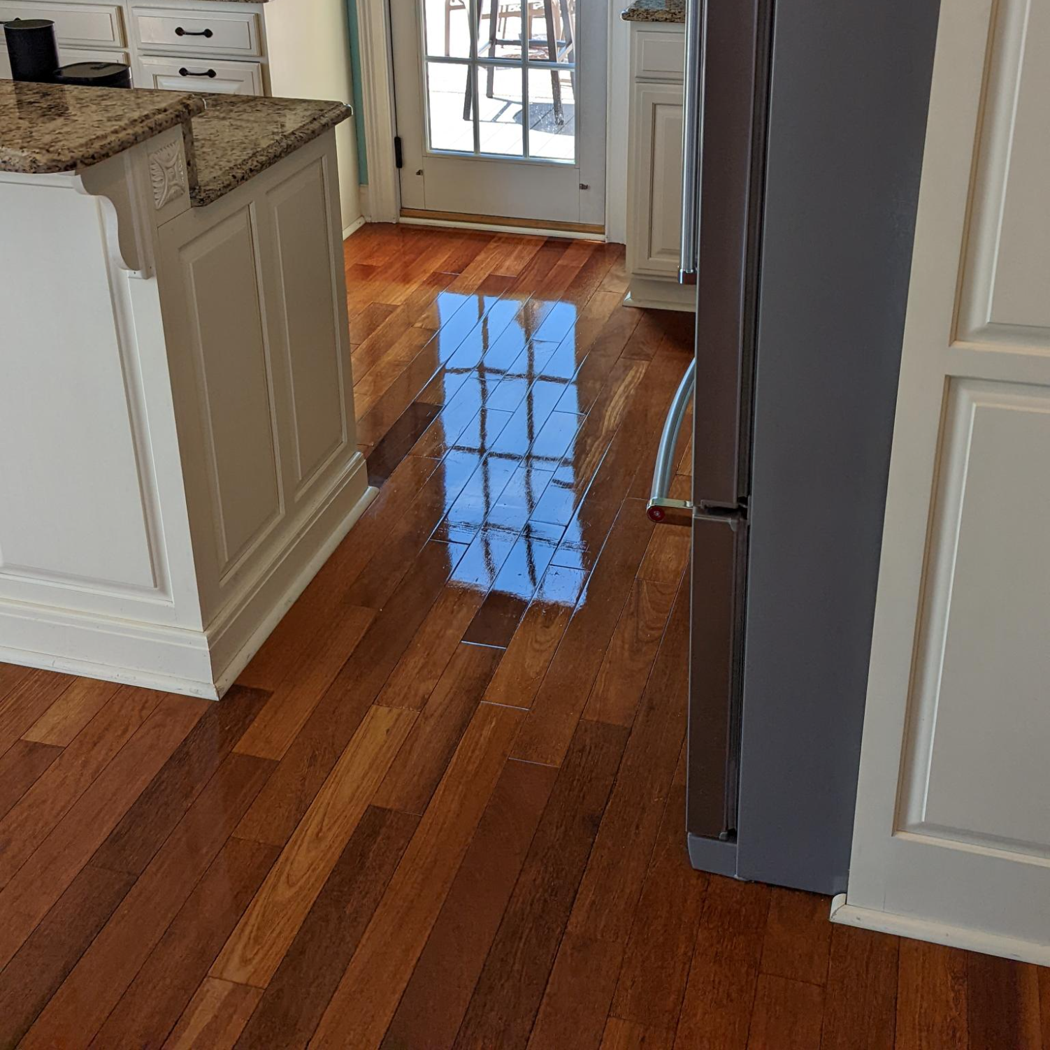 Shiny hardwood floor that isn't slippery in a kitchen after being professionally cleaned by Zerorez®