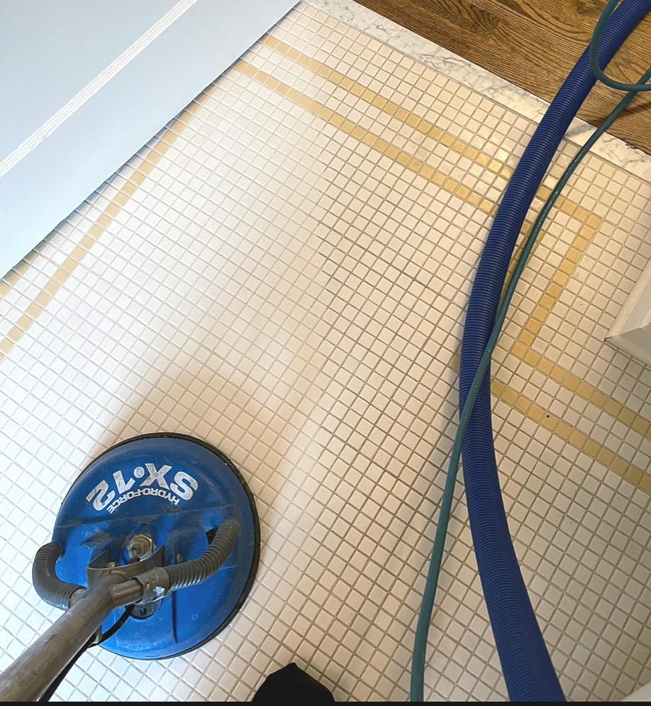 a white tiled floor with yellow grout lines on the right side of the flooring