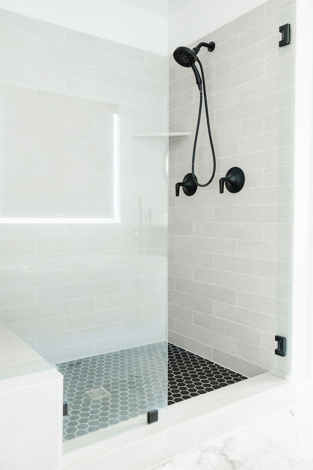 how to stain grout lines in a bathroom shower with lots of different tiles and white grout lines