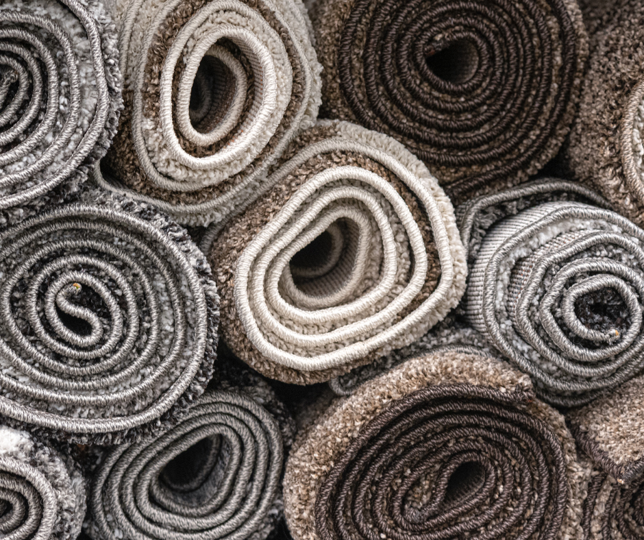 rolls of wool carpet in gray, black, brown, white and cream