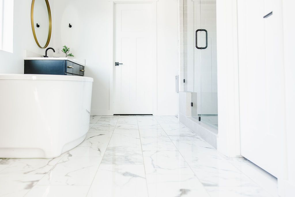 white porcelain or ceramic tile floor in a white bathroom
