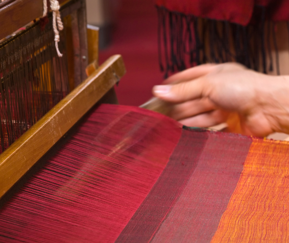 spinning red yarn to make a handmade carpet or rug