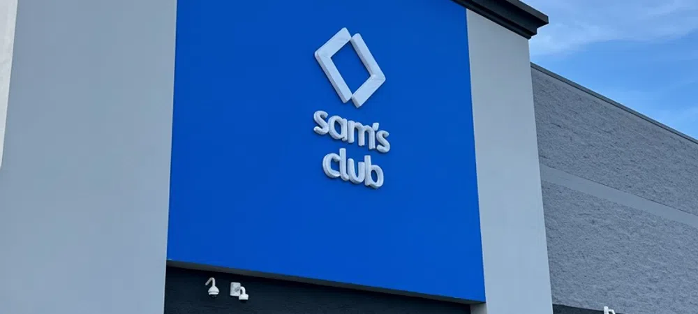 Exterior of a Sam's Club store with a large blue sign and clear sky background