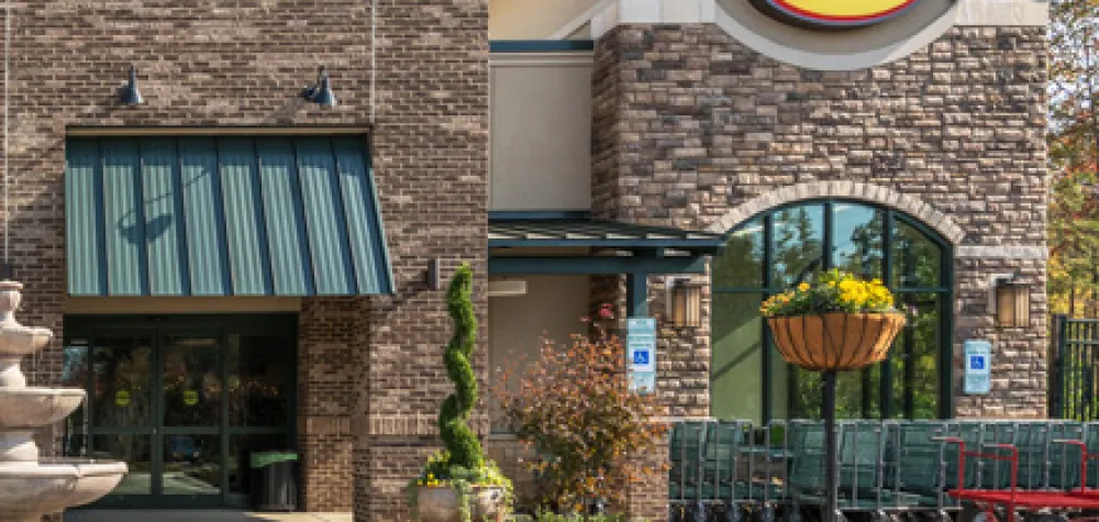 a building that has a sign on the side of a road