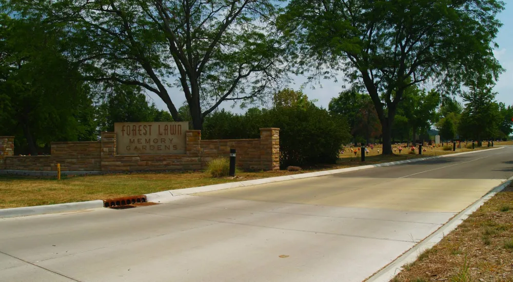a road with trees and a sign