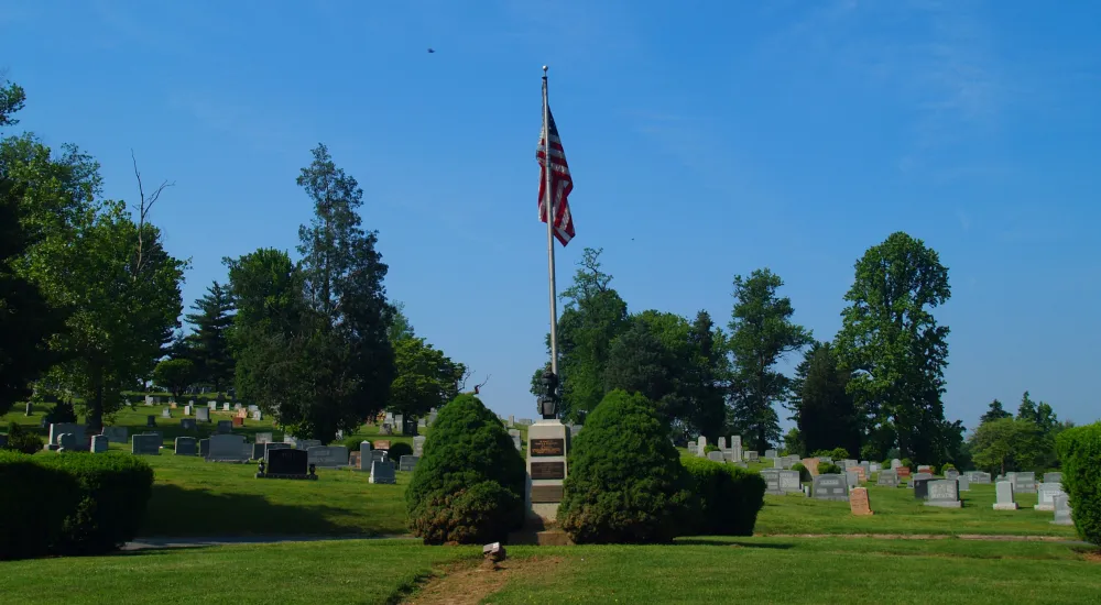 a flagpole in a cemetery