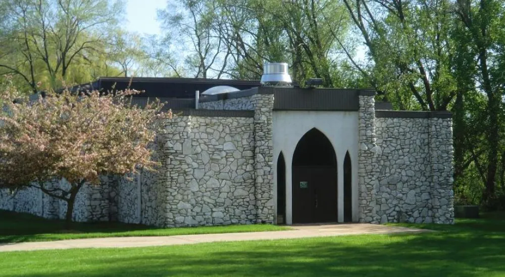 a stone building with a stone wall with Washington's Headquarters in the background